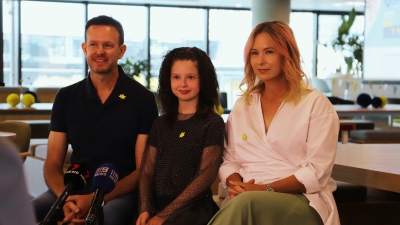 Imogen and her parents speaking to the media on Cancer Research Giving Day